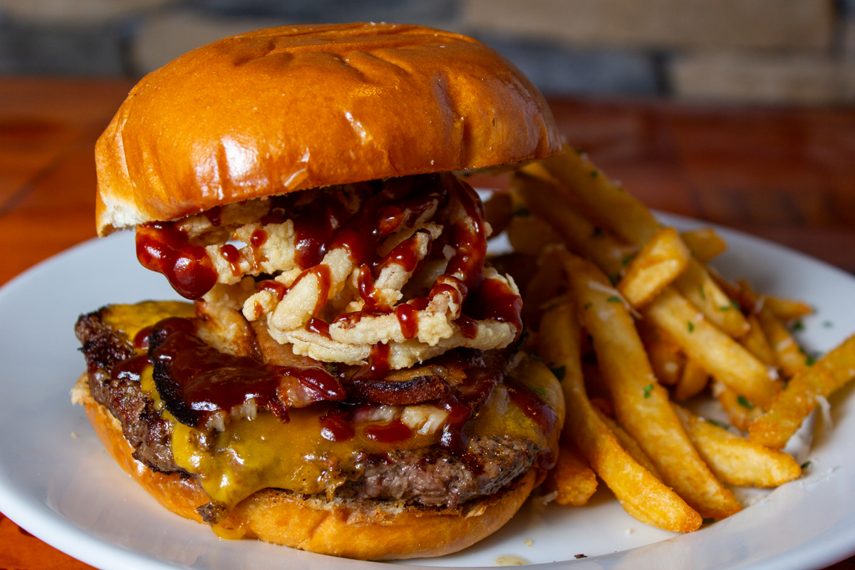 The_Durango_20220830 - 003comp Example of Food Photography for DoorDash, Uber Eats, Grub Hub, and any food delivery service app. Food Photo is of a juicy hamburger with onion rings and fries.