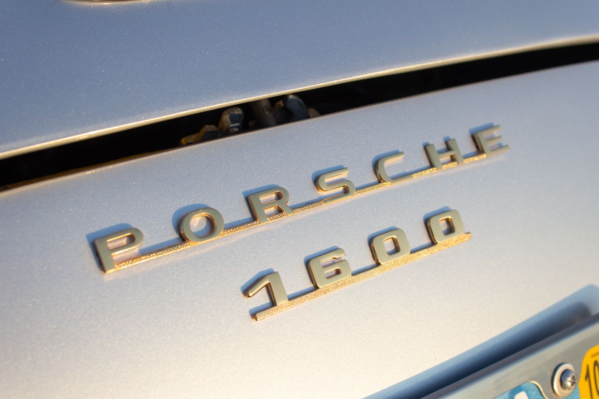 Porsche_2023062023 (26)comp Example of Automotive Photography. Car Photography and Videography for Bring-a-Trailer, Auto Hunter, Barn Finder, Auto Trader, and any car and automobile sales sites. Car Photo is of the logo of a light blue Porsche.