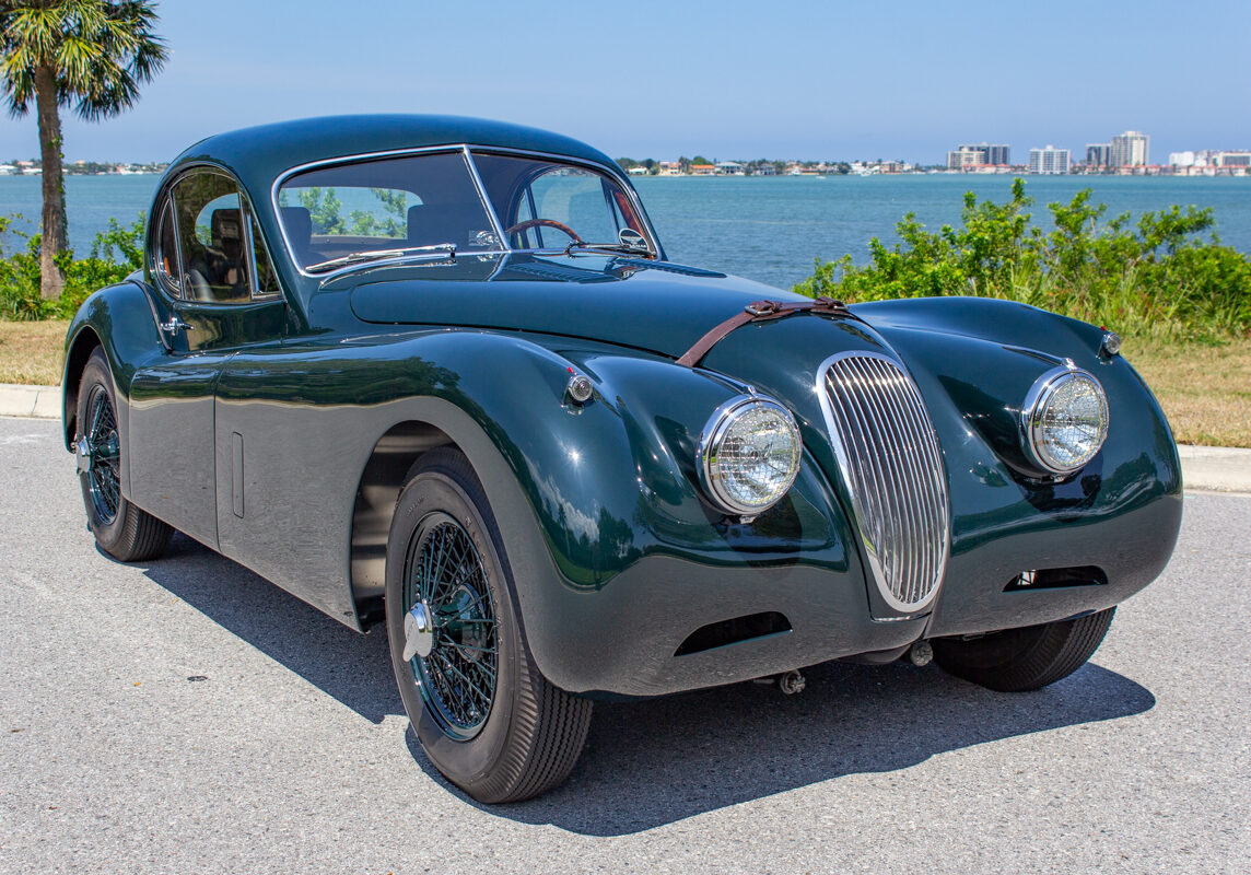 1953_Jaguar_XK120_20230520 (137)comp Example of Automotive Photography. Car Photography and Videography for Bring-a-Trailer, Auto Hunter, Barn Finder, Auto Trader, and any car and automobile sales sites. Car Photo is of a green 1953 Jaguar XK120 from the passenger's side front. The photo features a view of the Gulf of Mexico in the background.