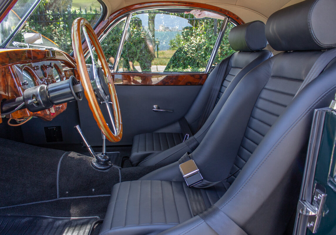 1953_Jaguar_XK120_20230520 (138)comp Example of Automotive Photography. Car Photography and Videography for Bring-a-Trailer, Auto Hunter, Barn Finder, Auto Trader, and any car and automobile sales sites. Car Photo is a tight shot of the driver's side front interior of a green 1953 Jaguar XK120