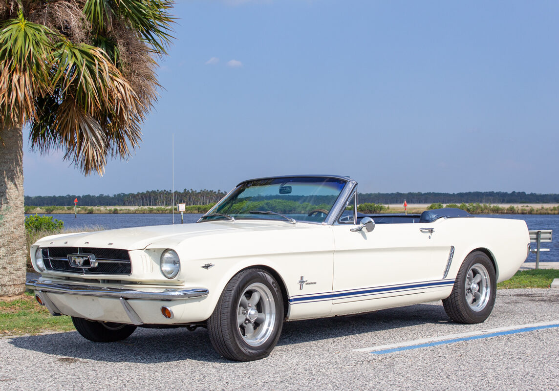 1965_Ford_Mustang_Convertible_20230630 (73)comp Example of Automotive Photography. Car Photography and Videography for Bring-a-Trailer, Auto Hunter, Barn Finder, Auto Trader, and any car and automobile sales sites. Car Photo is of a 1965 Ford Mustange Convertible. It is cream colored. The photographs were taken at the beach so there is water behind the car from the Gulf of Mexico.