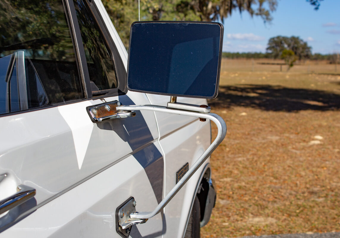 Ford_F250_20250207 - (132)comp Example of Automotive Photography. Car Photography and Videography for Bring-a-Trailer, Auto Hunter, Barn Finder, Auto Trader, and any car and automobile sales sites. Car Photo is of the passenger's side mirror of a white Ford F-250