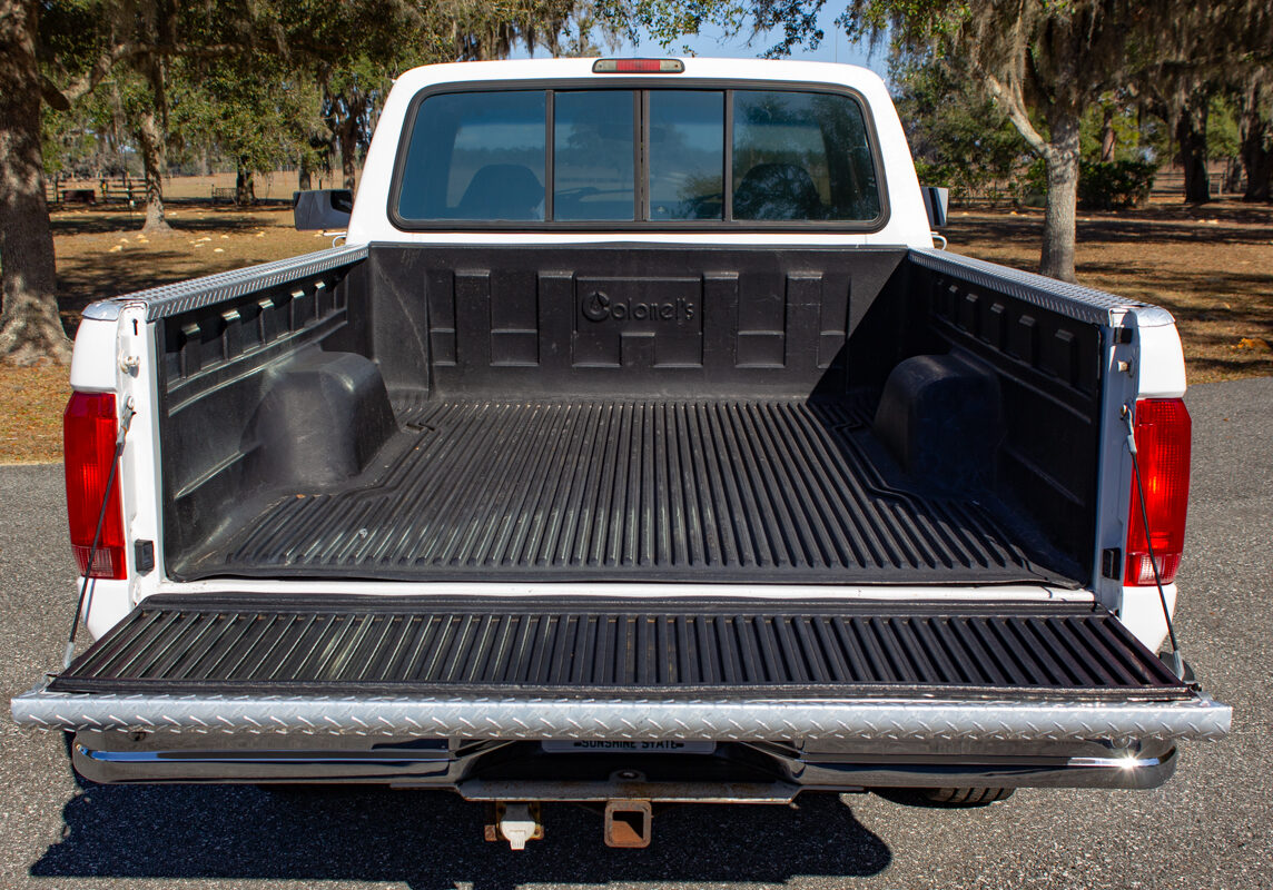 Ford_F250_20250207 - (143)comp Example of Automotive Photography. Car Photography and Videography for Bring-a-Trailer, Auto Hunter, Barn Finder, Auto Trader, and any car and automobile sales sites. Car Photo is of the bed of a white Ford F-250 with the tail gate open.