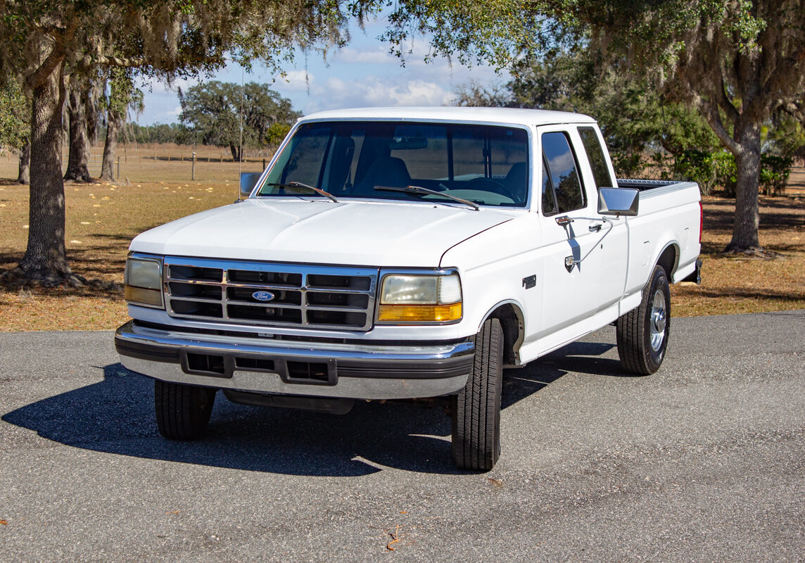 Ford_F250_20250207 - (2)comp Example of Automotive Photography. Car Photography and Videography for Bring-a-Trailer, Auto Hunter, Barn Finder, Auto Trader, and any car and automobile sales sites. Car Photo is of white Ford-F250 from the driver's side front of the vehicle. It has a ranch with horses in the background